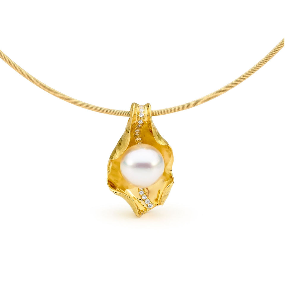 Gold diamond and pearl pendant and a gold collar. Pearl is encased with the gold cupping the pearl and a trail of diamonds through the middle.